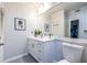 Bright bathroom featuring a vanity with ample storage and a large mirror at 240 Renaissance Ne Pkwy # 106, Atlanta, GA 30308