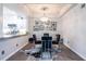 Elegant dining area with a modern chandelier and a view into the kitchen at 240 Renaissance Ne Pkwy # 106, Atlanta, GA 30308