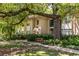 An exterior view of the building with lush landscaping, sidewalks, and a bench at 240 Renaissance Ne Pkwy # 106, Atlanta, GA 30308