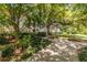 Beautiful condo complex with lush landscaping and a serene walking path at 240 Renaissance Ne Pkwy # 106, Atlanta, GA 30308