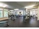 Well-equipped fitness center with weights, machines, and mirrored wall, with lots of natural light at 240 Renaissance Ne Pkwy # 106, Atlanta, GA 30308