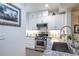 Well-lit kitchen showcasing stainless steel appliances and granite countertops at 240 Renaissance Ne Pkwy # 106, Atlanta, GA 30308