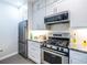 Contemporary kitchen boasts stainless steel appliances and ample cabinet space at 240 Renaissance Ne Pkwy # 106, Atlanta, GA 30308
