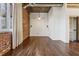 Open and minimalist bedroom with hardwood floors and brick accent wall at 3235 Roswell Ne Rd # 421, Atlanta, GA 30305