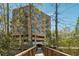 Brick condo building exterior shot showing mature trees, bridge, and architectural details at 3235 Roswell Ne Rd # 421, Atlanta, GA 30305