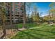 Brick building with lush green space, walking bridge, and mature trees at 3235 Roswell Ne Rd # 421, Atlanta, GA 30305
