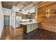 Open concept kitchen with stainless steel appliances, kitchen island, and wood accent wall at 3235 Roswell Ne Rd # 421, Atlanta, GA 30305
