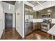 Modern kitchen with stainless steel appliances and olive green cabinets at 3235 Roswell Ne Rd # 421, Atlanta, GA 30305
