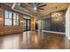 Living room with exposed brick walls, hardwood floors, and modern lighting at 3235 Roswell Ne Rd # 421, Atlanta, GA 30305