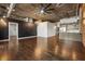 Contemporary living room with hardwood floors, industrial ceiling, and open kitchen space at 3235 Roswell Ne Rd # 421, Atlanta, GA 30305