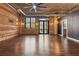 Spacious living room with hardwood floors, exposed brick, and modern lighting at 3235 Roswell Ne Rd # 421, Atlanta, GA 30305