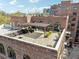 Expansive rooftop patio featuring pergola-covered seating area, planters, and access to brick building with arched windows at 3235 Roswell Ne Rd # 421, Atlanta, GA 30305