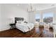 Bright bedroom featuring large windows, wood floors, and a chandelier at 5805 Clarion St., Cumming, GA 30040