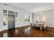 Bright dining room featuring hardwood floors, a brick accent wall, and a large window at 5805 Clarion St., Cumming, GA 30040