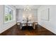Charming dining room with hardwood floors, a brick accent wall, and a large window at 5805 Clarion St., Cumming, GA 30040