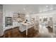 Modern kitchen featuring a spacious island, white cabinetry, stainless steel appliances, and hardwood flooring at 5805 Clarion St., Cumming, GA 30040