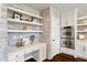 Bright kitchen with stainless steel appliances, desk area and white brick accent wall at 5805 Clarion St., Cumming, GA 30040