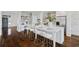 Bright, updated kitchen with a large island, brick accent wall, stainless appliances, and bar stool seating at 5805 Clarion St., Cumming, GA 30040