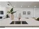 A close up of a modern kitchen island with a stainless steel sink and elegant faucet at 5805 Clarion St., Cumming, GA 30040