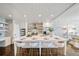 Bright, updated kitchen with a large island, brick accent wall, stainless appliances, and bar stool seating at 5805 Clarion St., Cumming, GA 30040
