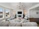 Bright and airy living room with a cozy fireplace and a picturesque view at 5805 Clarion St., Cumming, GA 30040