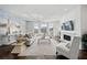 Elegant living room with a brick accent wall, fireplace, large windows, and neutral-toned furniture at 5805 Clarion St., Cumming, GA 30040