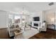 Bright living room with large windows, fireplace and hardwood floors at 5805 Clarion St., Cumming, GA 30040