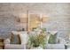 Living room features sofa with decorative pillows against a rustic brick wall at 5805 Clarion St., Cumming, GA 30040