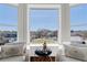 Sitting area featuring cushioned chairs, large windows, and natural light at 5805 Clarion St., Cumming, GA 30040