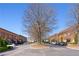 Street view of the community with brick buildings and ample parking spaces on a sunny day at 5805 Clarion St., Cumming, GA 30040