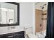 Cozy bathroom with shower and tub combination, tiled accent wall, and single sink vanity at 1112 Park S Row, Atlanta, GA 30312