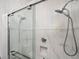 Contemporary walk-in shower with dual shower heads, glass doors, and marble style tile surround at 1112 Park S Row, Atlanta, GA 30312