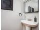 Elegant bathroom showcasing a pedestal sink with modern fixtures and stylish mirror at 1112 Park S Row, Atlanta, GA 30312