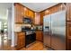 Well-equipped kitchen with stainless steel appliances and wood cabinets at 1112 Park S Row, Atlanta, GA 30312