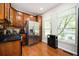 Modern kitchen with stainless steel refrigerator, granite countertops, and wood floors at 1112 Park S Row, Atlanta, GA 30312