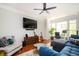 Cozy living room featuring a plush blue sofa, decorative pillows, and hardwood floors at 1112 Park S Row, Atlanta, GA 30312
