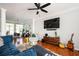Comfortable living room with modern ceiling fan, large TV, and stylish decor with warm, natural light at 1112 Park S Row, Atlanta, GA 30312