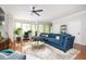 Spacious living room featuring a plush blue sofa, modern decor, and ample natural light at 1112 Park S Row, Atlanta, GA 30312