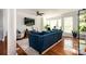 Open-concept living area featuring a plush sofa, modern decor, with natural light streaming in from the windows at 1112 Park S Row, Atlanta, GA 30312