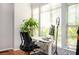 Bright office space with a modern adjustable desk, comfortable chair and natural light streaming through large windows at 1112 Park S Row, Atlanta, GA 30312