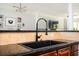 Close-up of a kitchen sink with modern fixture, set in front of warm-toned backsplash and granite counters at 1112 Park S Row, Atlanta, GA 30312