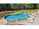 Beautiful backyard featuring a sparkling pool, spa, and lush greenery, perfect for outdoor relaxation at 2698 Bonar Hall Path, Duluth, GA 30097