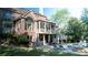 Back of house with a pool, spa, and stone outdoor kitchen, plus a screened-in porch and lush greenery at 2698 Bonar Hall Path, Duluth, GA 30097
