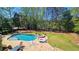 Gorgeous backyard showcasing a pristine pool, serene spa, and meticulously maintained lawn, creating a tranquil oasis at 2698 Bonar Hall Path, Duluth, GA 30097
