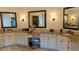 Bathroom featuring dual sinks, vanity, neutral color palette, granite countertop, and decorative mirrors at 2698 Bonar Hall Path, Duluth, GA 30097