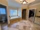 Bright bathroom featuring a soaking tub, walk-in shower, and separate closet at 2698 Bonar Hall Path, Duluth, GA 30097