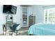 Charming bedroom with built-in shelving, a vanity, and large windows, creating a delightful space for relaxation at 2698 Bonar Hall Path, Duluth, GA 30097
