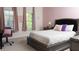 Cozy bedroom with soft pink walls, a comfortable bed, and a sunny window, creating a relaxing retreat at 2698 Bonar Hall Path, Duluth, GA 30097
