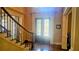 Grand foyer featuring hardwood floors, decorative front door, and elegant staircase with wrought iron details at 2698 Bonar Hall Path, Duluth, GA 30097