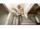 Elegant foyer showcasing a staircase with iron railings and a decorative chandelier at 2698 Bonar Hall Path, Duluth, GA 30097